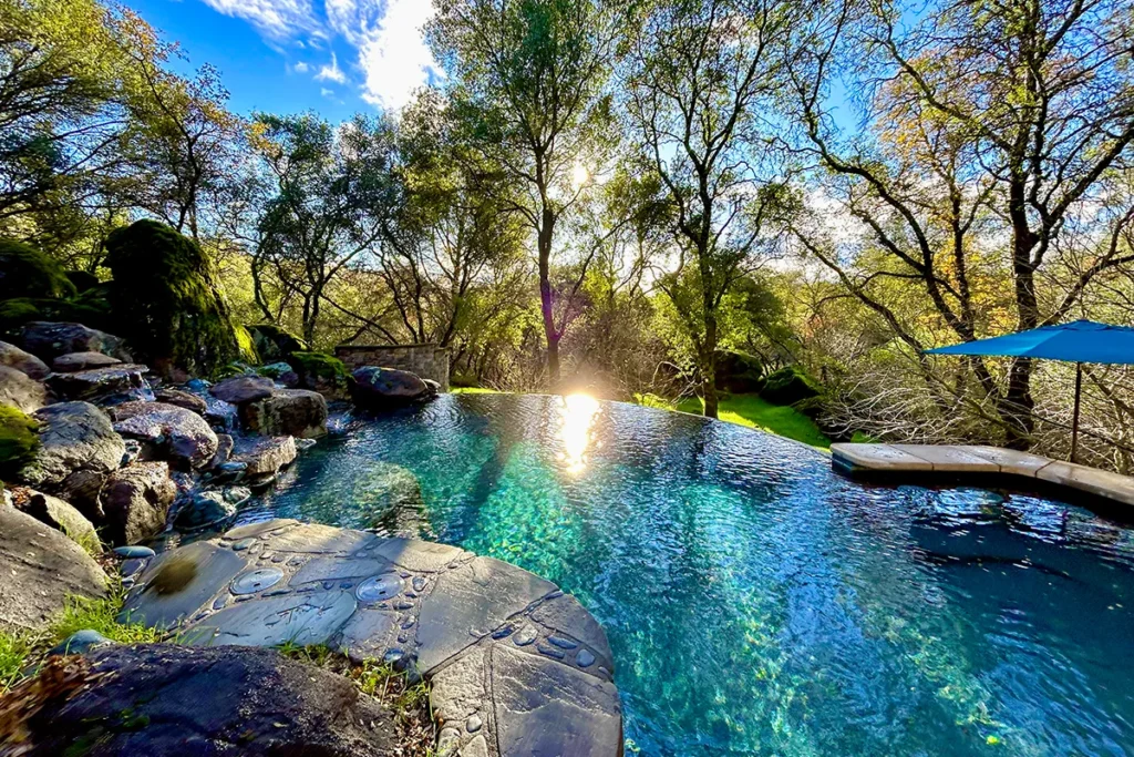Natural stone and oak tree backyard setting — Jim Chandler Pools design