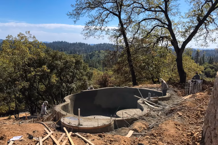 Completed gunite shell on a steep Colfax hillside following structural application and shaping.
