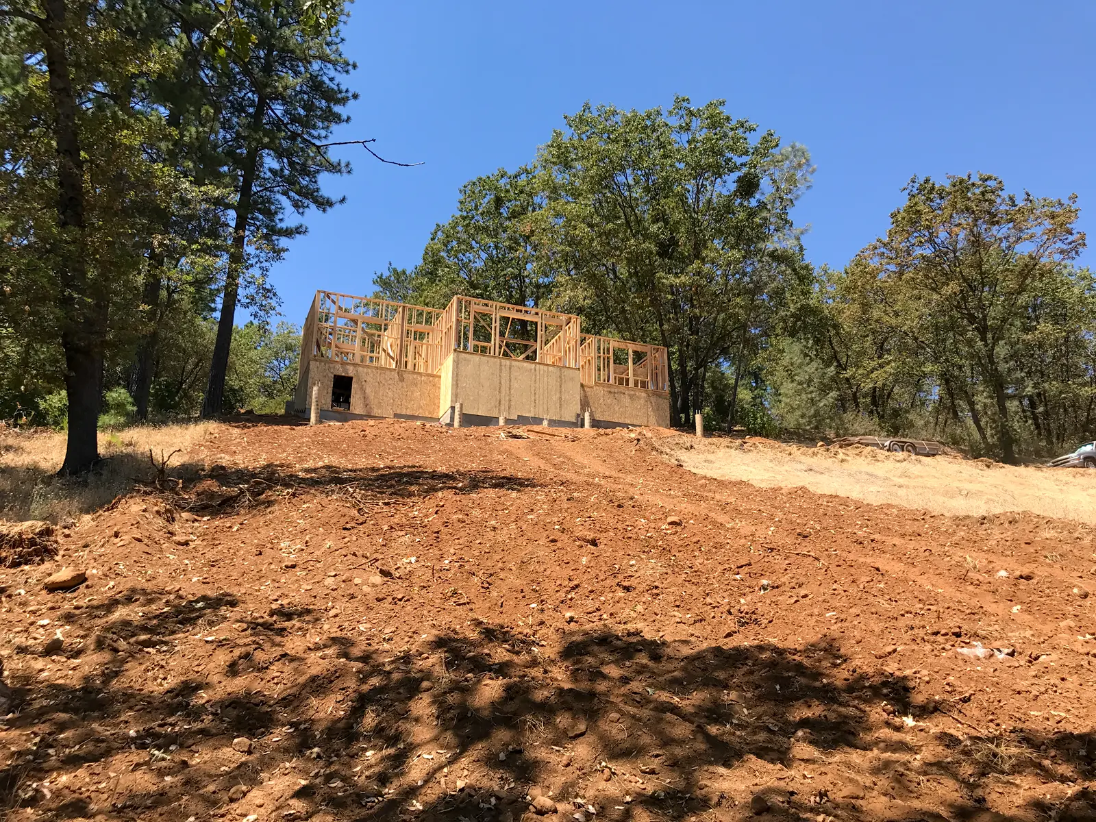 Home under construction on a steep Colfax hillside supported by engineered stepped footings