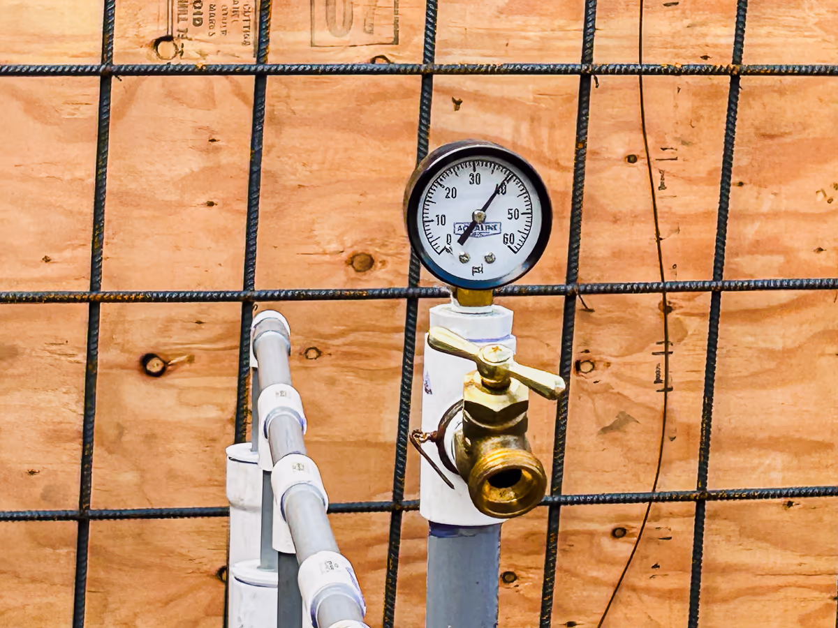 Pool plumbing pressure test gauge reading 39 PSI before gunite on small yard hillside pool in Rocklin CA