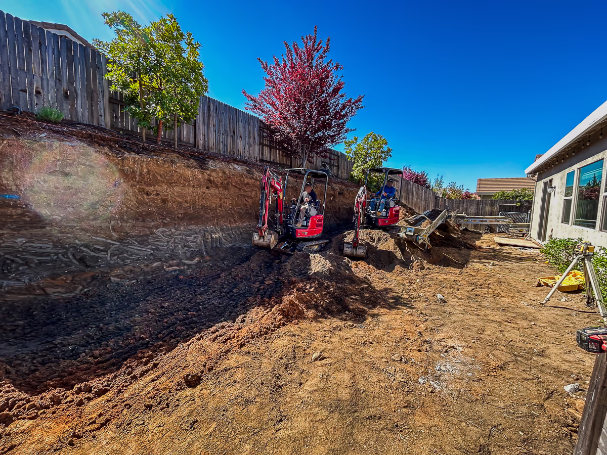 Yanmar mini excavators working against a full height cut wall during pool excavation in Rocklin CA