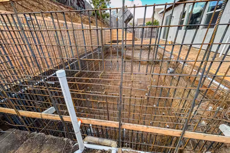Complete pool shell rebar and retaining wall system before gunite in Rocklin CA backyard