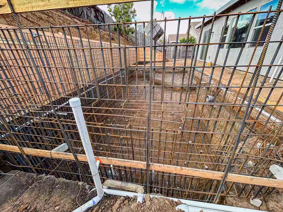 Complete pool shell rebar and retaining wall system before gunite in Rocklin CA backyard