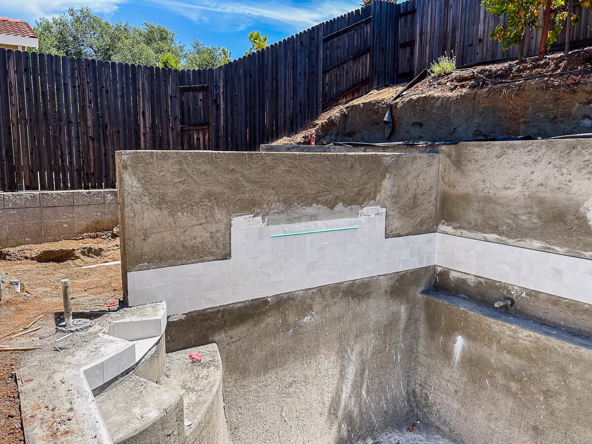 Slate White 6x6 waterline tile installed with CMP Classic Falls 48-inch sheer descent on custom gunite pool retaining wall in Rocklin California