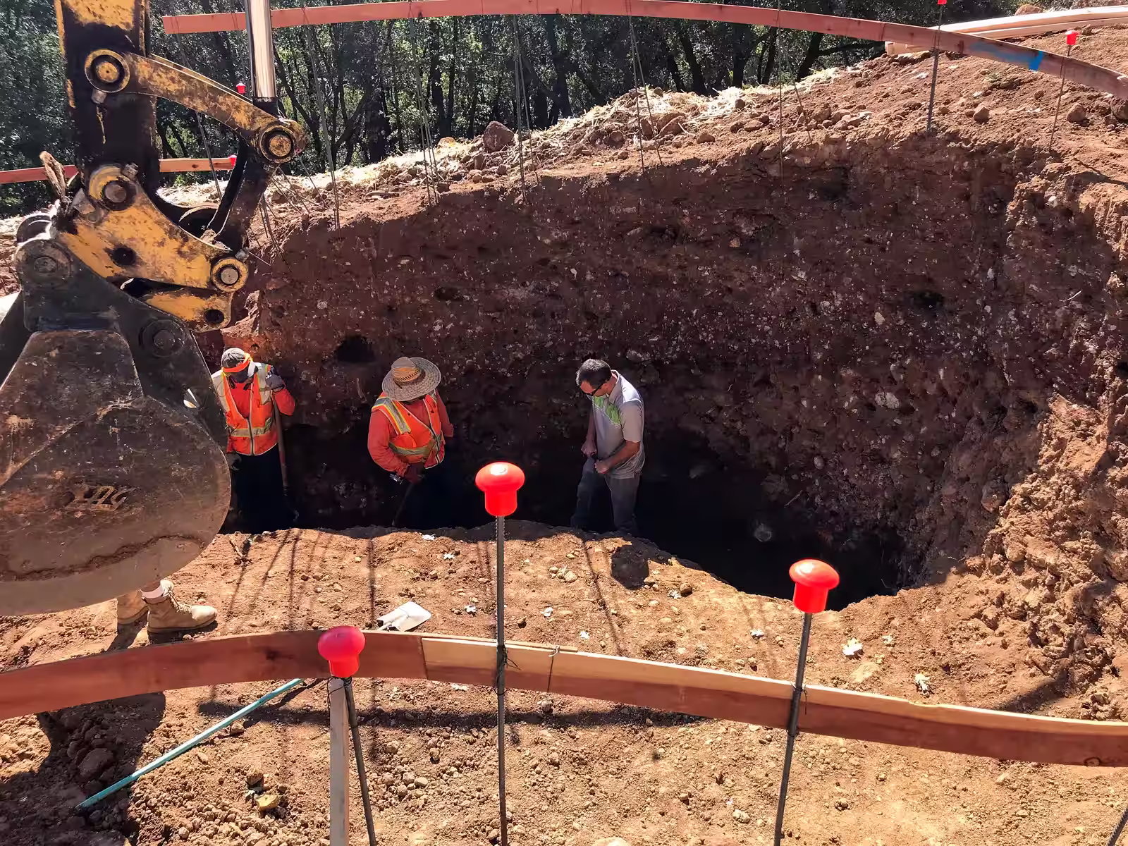 Geotechnical engineer inspecting soil conditions at 14-foot excavation depth for Colfax vanishing edge pool — confirming native soil before gunite placement