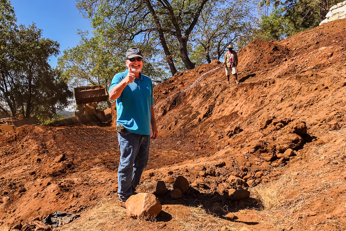 Jim Chandler, founder of Jim Chandler Pools, on a hillside pool excavation site in the Sierra Foothills