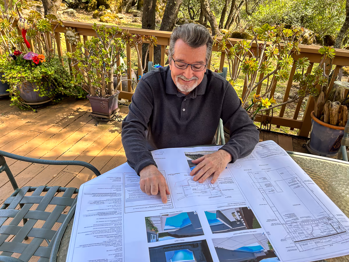 Jim Chandler reviewing custom pool design plans for Jim Chandler Pools